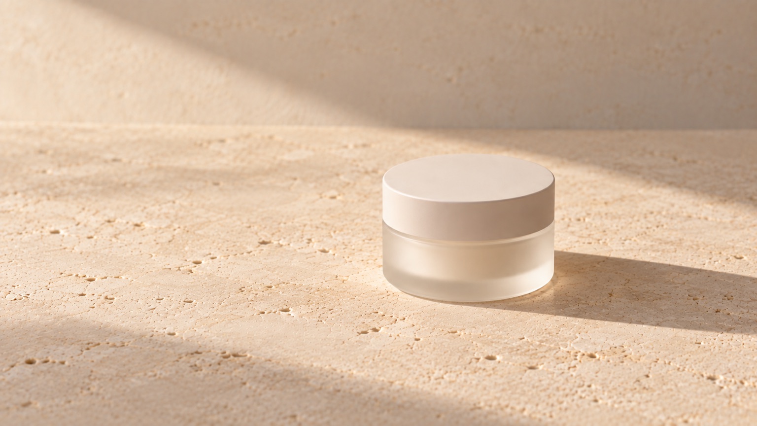 A single plain matte jar standing alone on warm porcelain in even neutral daylight with generous empty space.